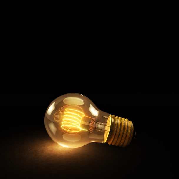 Glowing Incandescent Light Bulb on a Dark Background - Photo, image