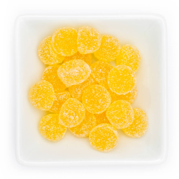 dried yellow and white jelly balls on a plate - Photo, Image