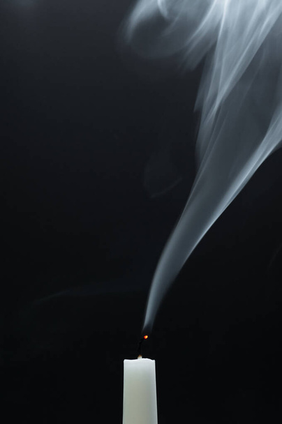 burning candle on black background - 写真・画像