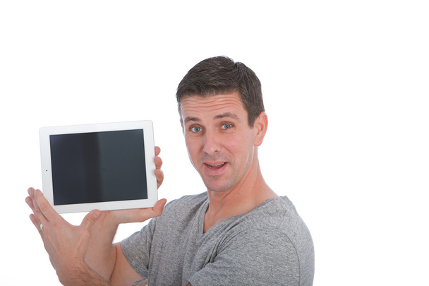 Handsome charismatic man showing off a tablet - Photo, Image