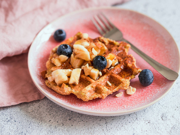 Easy healthy gluten free oat waffles with copy space. Appetizing homemade waffles with oat flour decorated blueberries, on plates over light gray cement background - Фото, изображение