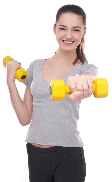 Young girl lifting barbells on a white background - Fotografie, Obrázek