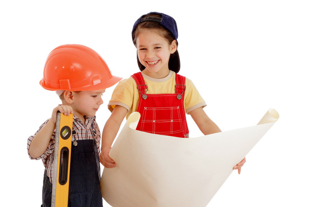 Two smiling little builders planning with liquid level and blueprint - Photo, Image