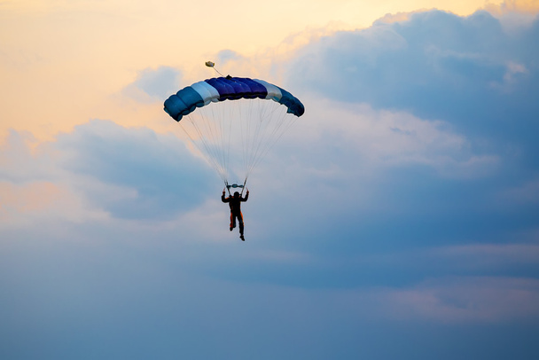正体不明のスカイダイバー、青い空に落下傘兵 - 写真・画像