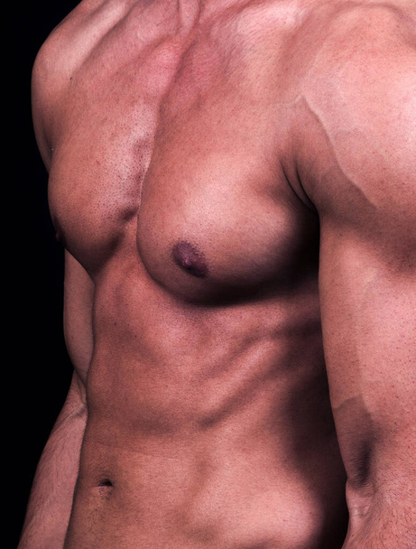 muscular man with naked torso on black background - Fotografie, Obrázek