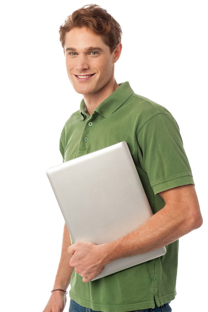 Smiling young man holding laptop - Foto, Imagem