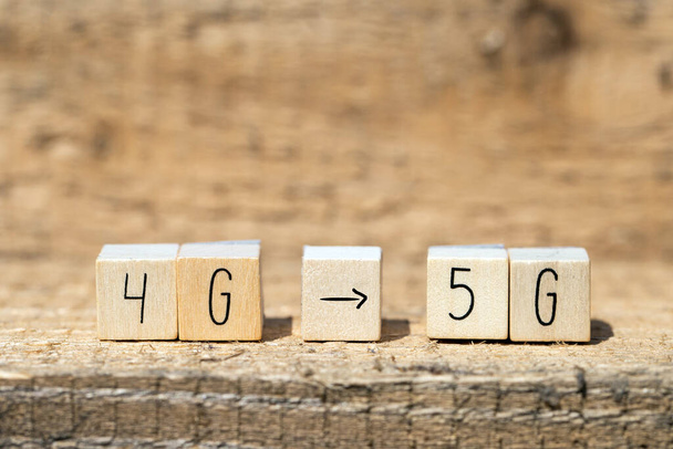 Wooden cubes From 4g To 5g with black arrow pointing On wooden background, mobile or technology concept closeup - Photo, Image