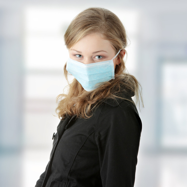 A model wearing a mask to prevent 'Swine Flu' infection. - Zdjęcie, obraz