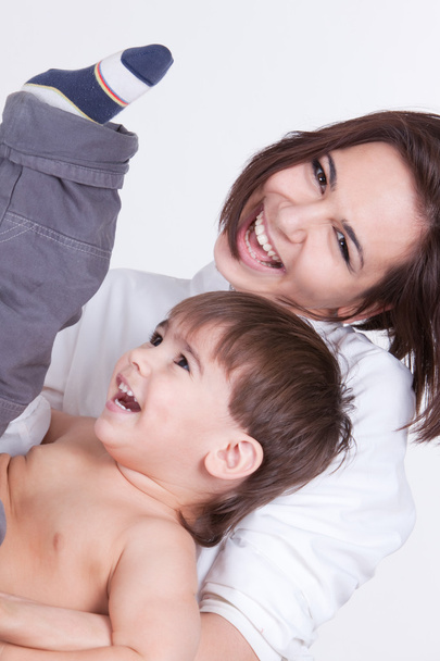 Happy smiling mother playing with her son - 写真・画像