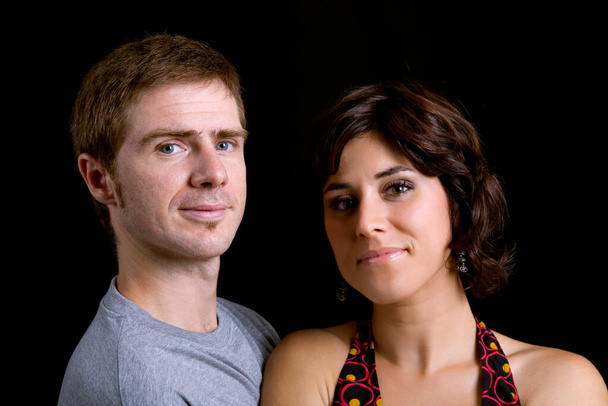 portrait of a young couple on a black background - Фото, зображення