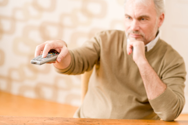 Senior mature man with remote control - Zdjęcie, obraz
