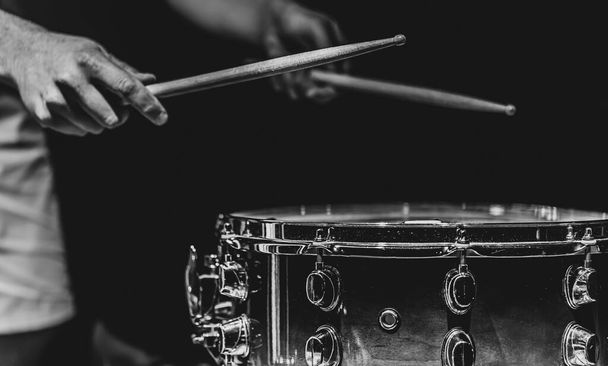 A man plays a snare drum with sticks, a drummer plays a percussion instrument, close up. - Photo, Image