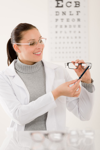 Optician doctor woman with glasses and eye chart - Фото, изображение