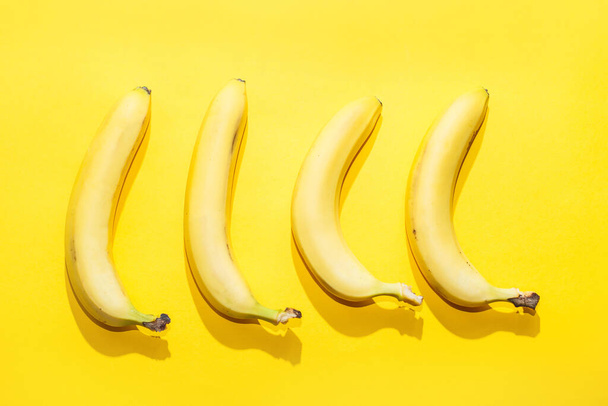 Bananas on yellow pastel background. minimal idea food concept. - Фото, изображение