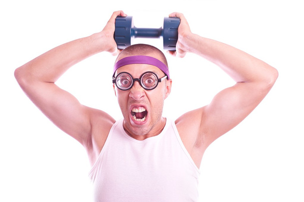 Nerd in glasses with dumbbell trains - Photo, Image