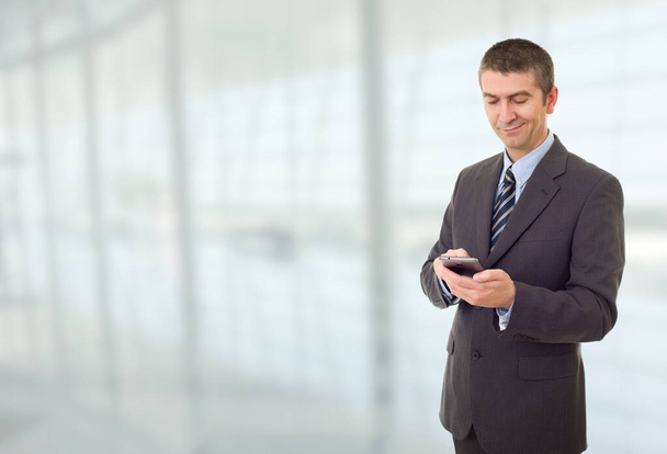 portrait of a young businessman with a mobile phone - Foto, Bild