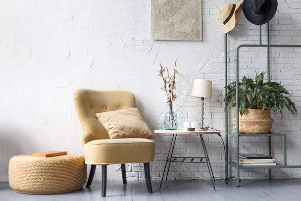 stylish interior of modern living room with comfortable sofa and chair - Фото, зображення