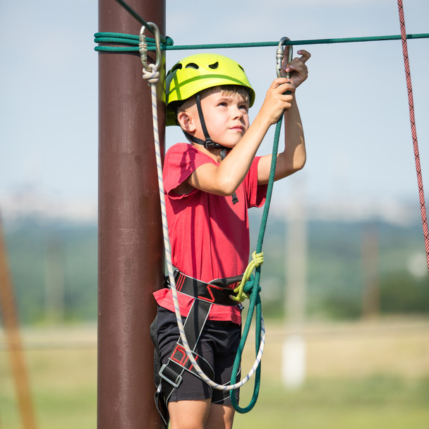 Boy climbing in adventure park - Фото, изображение