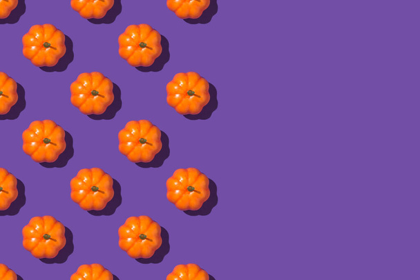 Top view photo of orange pumpkins on isolated violet background with empty space - Φωτογραφία, εικόνα