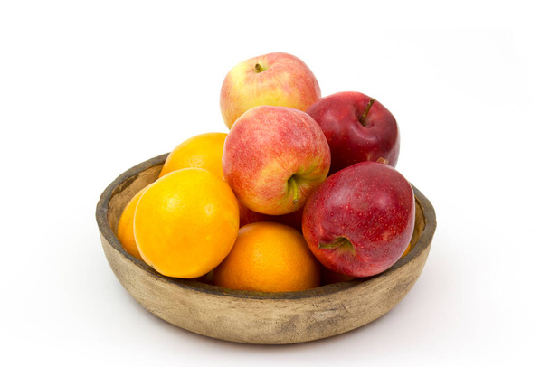 fresh fruits in a clay bowl - oranges and apples - Foto, Imagem