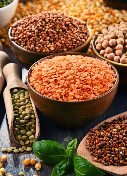 different types of lentils in bowls on wooden background - Foto, Imagen