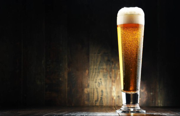 Composition with glass of beer on wooden background. - Foto, immagini