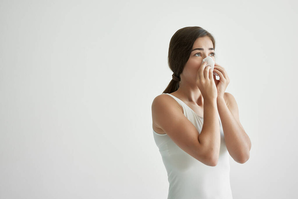 woman in white tank top handkerchief runny nose health problems - Фото, изображение