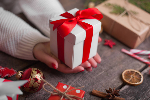 Gift box in wrapping paper with satin ribbon. Merry Christmas holiday concept. - Φωτογραφία, εικόνα