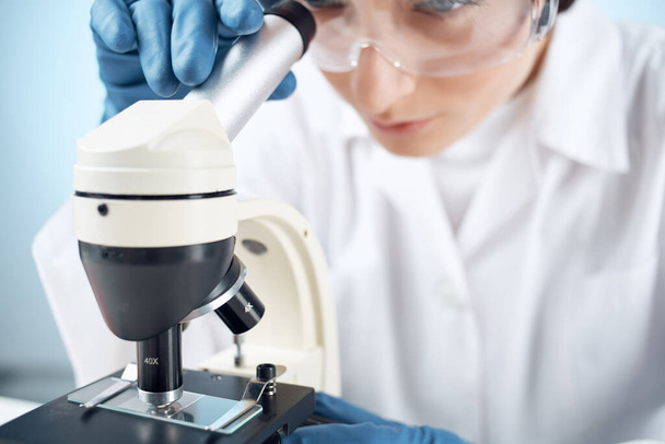 female laboratory assistant in medical gloves microscope biotechnology medicine - Fotoğraf, Görsel