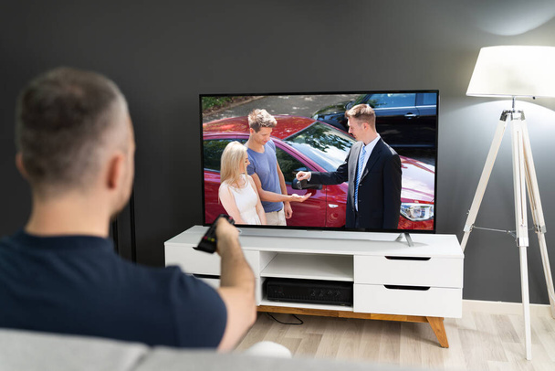 Man Streaming And Watching Movie On TV Screen - Foto, Bild