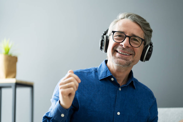 Smiling Older Senior Listening Music On Headphones - Foto, imagen