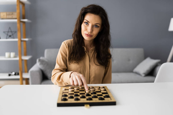 Woman Playing Checkers Online Using Video Conference Call - Foto, Imagem