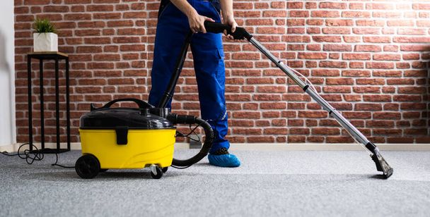 Janitor Cleaning Carpet With Vacuum Cleaner At Home - Fotoğraf, Görsel