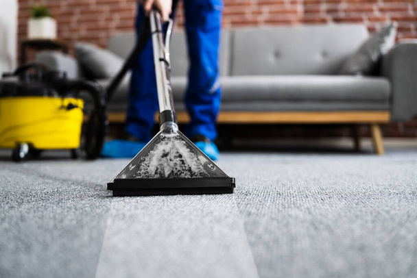 Janitor Cleaning Carpet With Vacuum Cleaner At Home - Foto, Bild