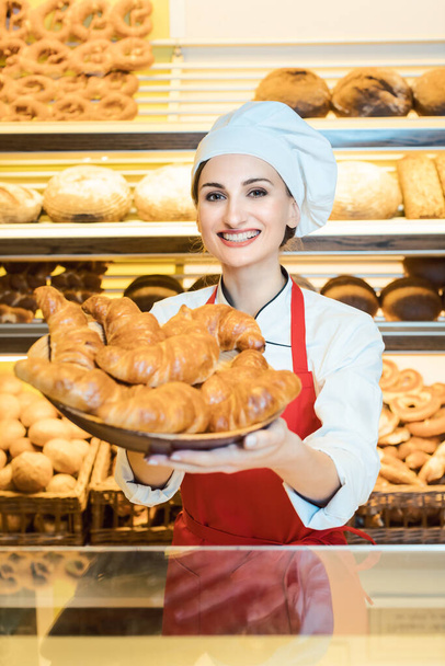 portrait of female baker wearing apron standing at bakery shop - Фото, зображення