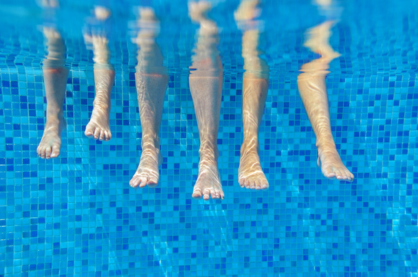 Funny underwater family legs in swimming pool - Foto, Imagen