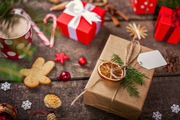 Gift box in wrapping paper with satin ribbon. Merry Christmas holiday concept. - 写真・画像