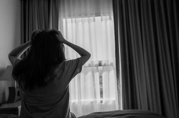 Selective focus on stressed and depressed woman holding head and pulling hair. Nervous person. Mental health and dementia. Worry and anxiety young woman. Unhappy wife.Thoughtful woman in dark room. - Fotografie, Obrázek