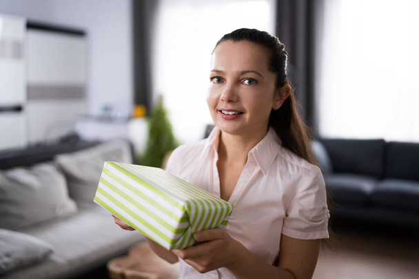 Happy Woman Sitting At Home Opening Gift - Foto, Imagem