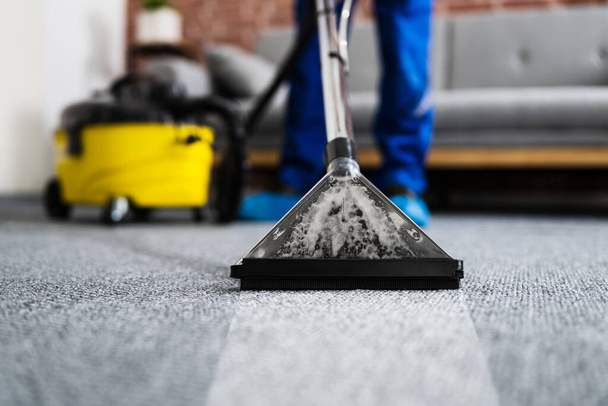 Janitor Cleaning Carpet With Vacuum Cleaner At Home - Photo, image