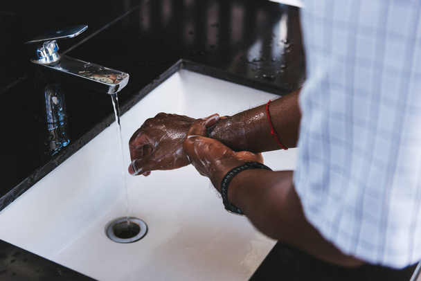 Closeup washing black man hands rubbing with soap and water in sinks to prevent outbreak coronavirus hygiene to stop spreading virus, hygiene for quarantine cleaning COVID-19 concept - Φωτογραφία, εικόνα