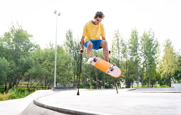 amputated skater spending time at the skatepark. concept about disability and sports - 写真・画像