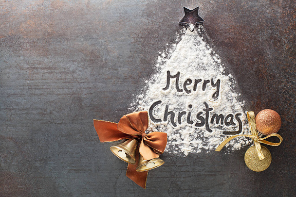 Merry Christmas text made with flour with decorations objects. Christmas, winter, new year concept background. - Foto, Imagem