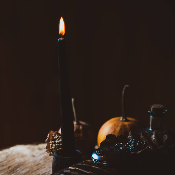 Candle burns on the altar, magic among candles, clean energy, magical concept, autumn time - Photo, Image