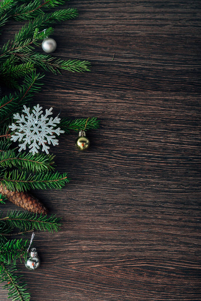 Decoration of Christmas Tree Branches and Snowflakes on a Brown Background with Copy Space - Photo, Image