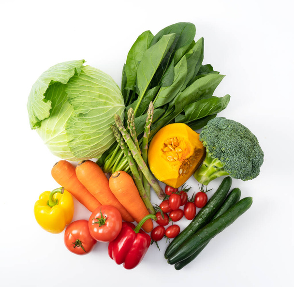 Many kinds of vegetables placed on a white background. View from above - Zdjęcie, obraz
