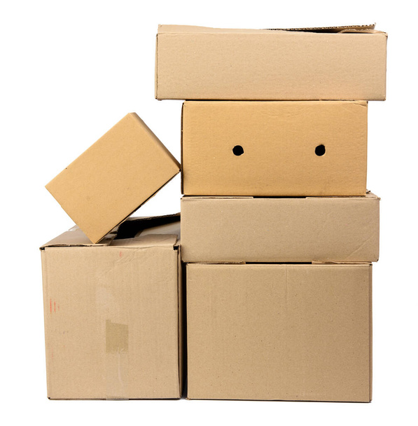 stack of closed cardboard brown paper boxes isolated on white background, moving concept - Valokuva, kuva