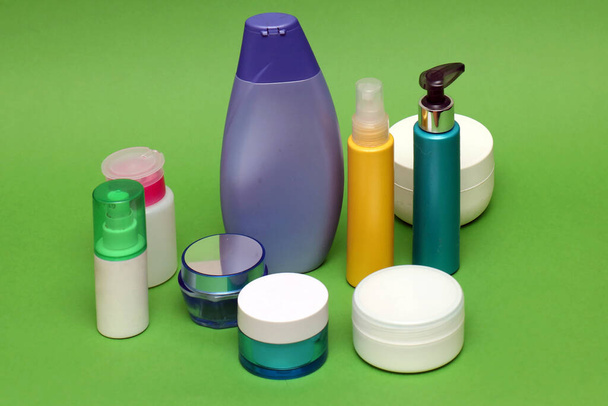 Colorful plastic and glass closed toiletries bottles beauty creams and cosmetics - Photo, Image