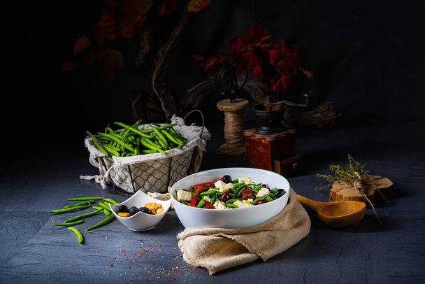 Spicy green bean salad with olives, feta cheese and dried tomatoes - Photo, Image