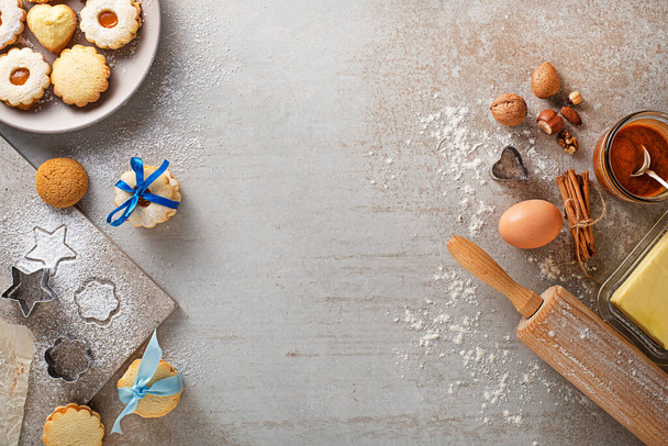 Making and baking cut-out sugar cookies of all shapes and sizes. Holidays, celebration and cooking concept. - 写真・画像